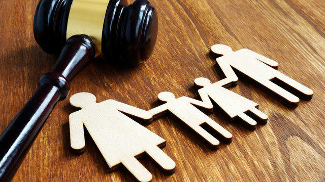 Gavel next to cut out of family holding hands