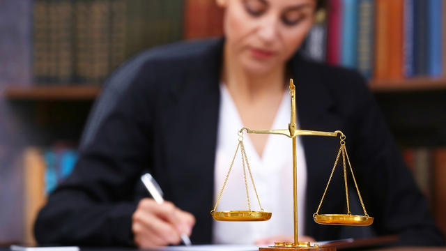 Female lawyer and scales of justice