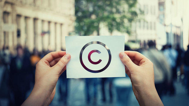 Person holding paper with copyright symbol