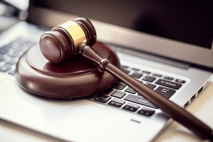 Gavel on top of laptop keyboard