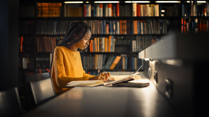 Female college student studying in the library