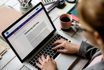 Woman on laptop reading about LSAT-Flex