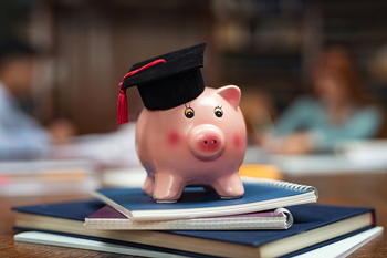 Piggy bank on top of notebooks
